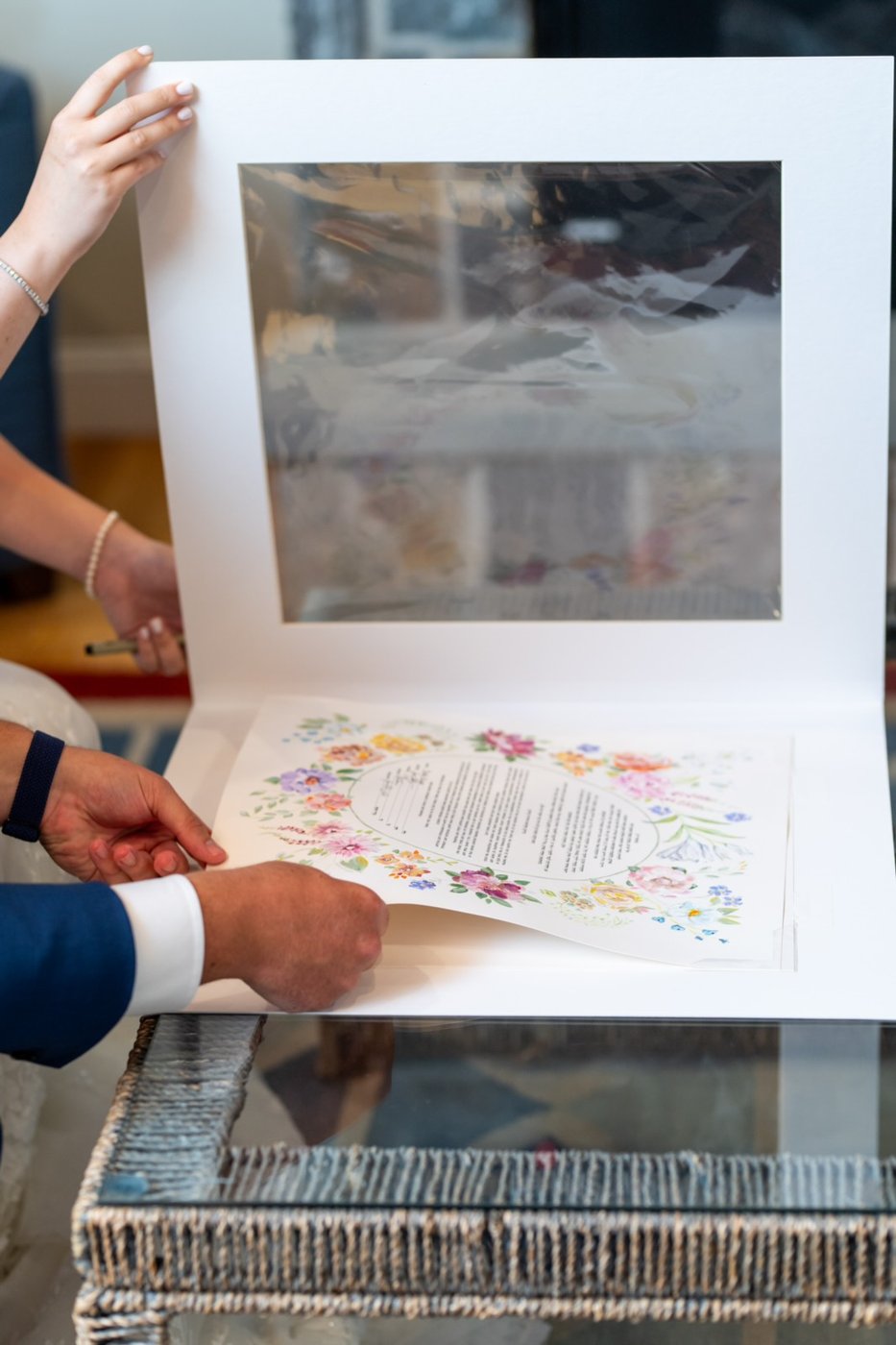Couple holding an open ketubah