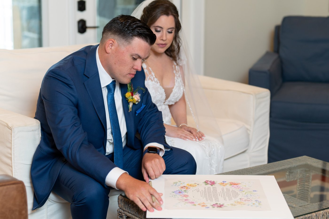 Couple signing their ketubah